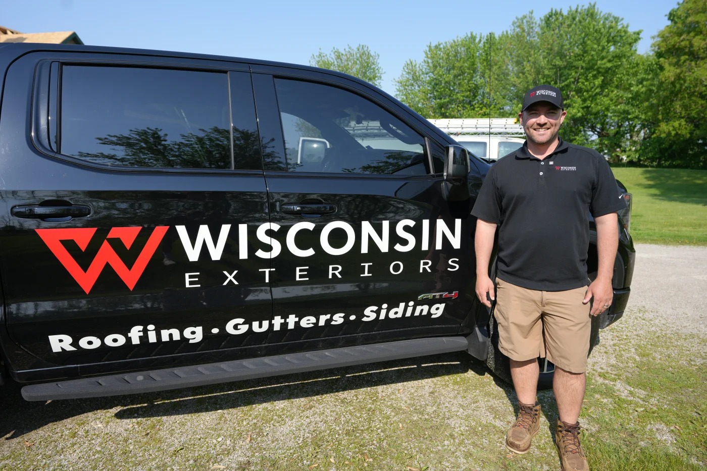 One Point Of Contact | Kaukauna | Wisconsin Exteriors Owner of Wisconsin Exteriors standing in front of branded company truck