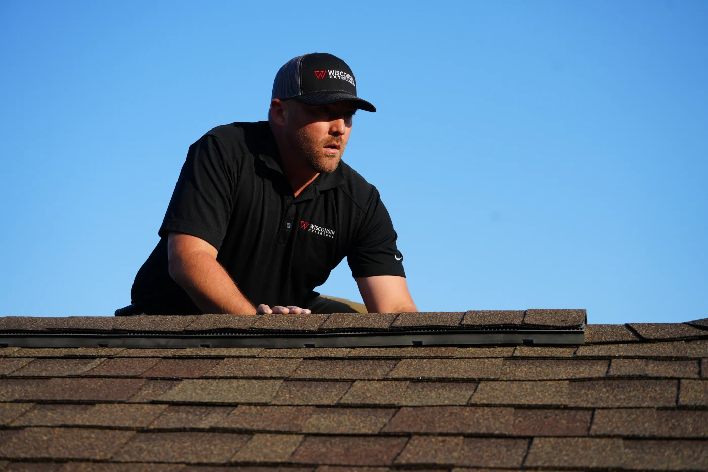 Owner of Wisconsin Exteriors inspecting a residential roof