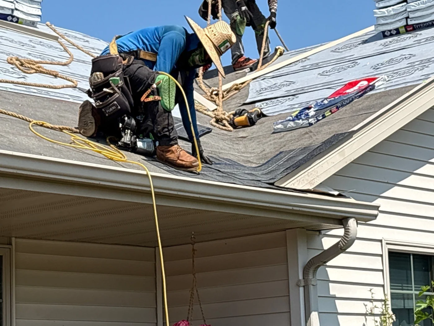 Expert Roof Replacement Kimberly Wi Wisconsin Exteriors Roofers completing a roof replacement on a white house.