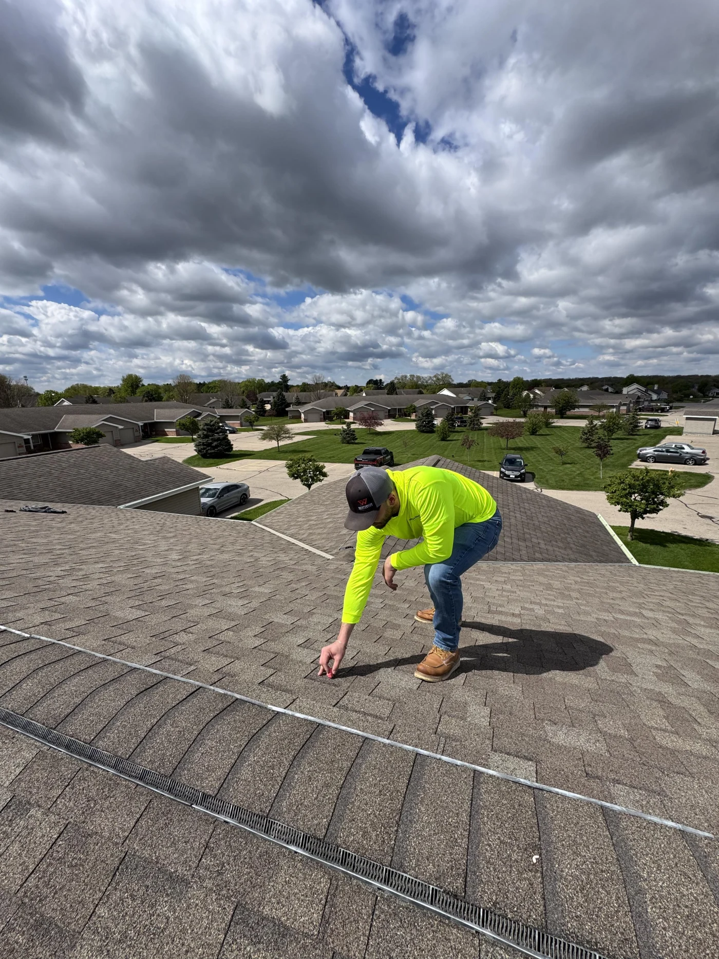 Precise Roof Inspection Neenah Wi Wisconsin Exteriors A roofer inspecting an asphalt shingle roof on a house