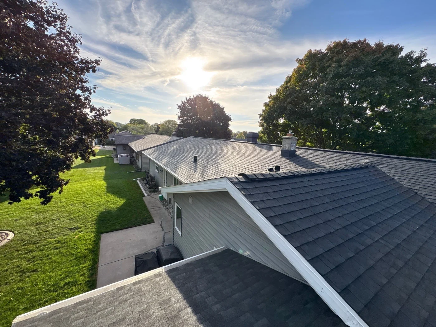 Professional Roofing Kaukauna Wi Wisconsin Exteriors A close-up view of an asphalt shingle roof on a gray house