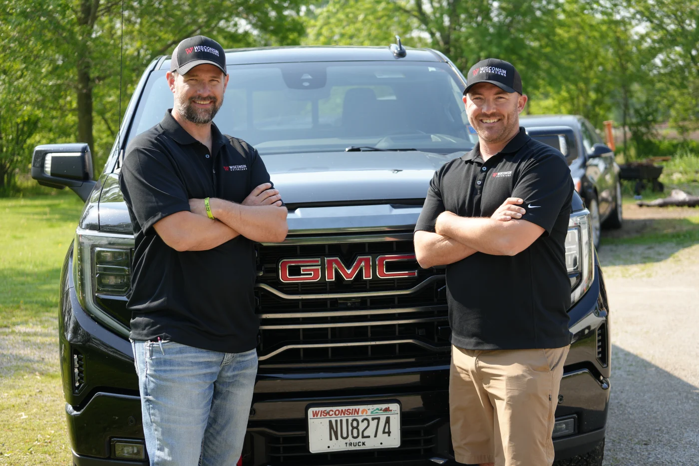 Our Roofing And Exteriors Crew | Wisconsin Exteriors | Kaukauna The owners of Wisconsin Exteriors smiling Infront of a truck